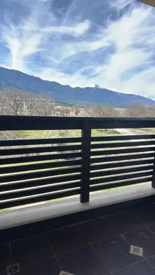 a view of the mountains from a train window at Alpine Lodge Bansko Apartments in Bansko