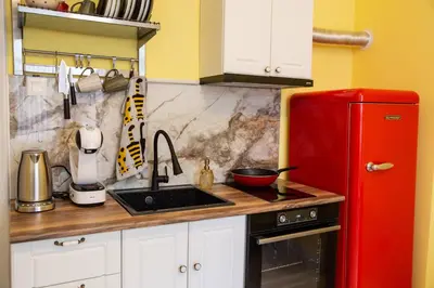 a kitchen with a red refrigerator and a sink at Apartment Serdika 1 in Sofia