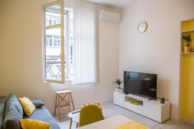 a living room with a couch and a television at Apartment Serdika 1 in Sofia