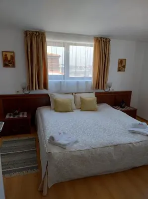 a bedroom with a bed with two towels on it at Gondola lift apartment 5401 in Bansko