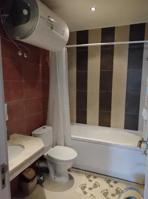 a bathroom with a toilet and a tub and a sink at Gondola lift apartment 5401 in Bansko