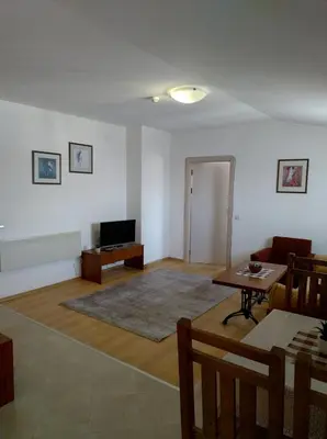 a living room with a couch and a table at Gondola lift apartment 5401 in Bansko
