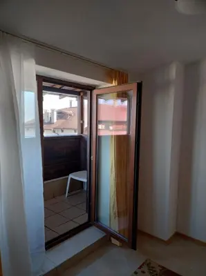 a room with a sliding glass door with a balcony at Gondola lift apartment 5401 in Bansko