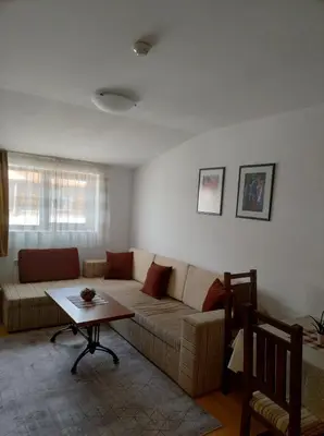 a living room with a couch and a table at Gondola lift apartment 5402 in Bansko