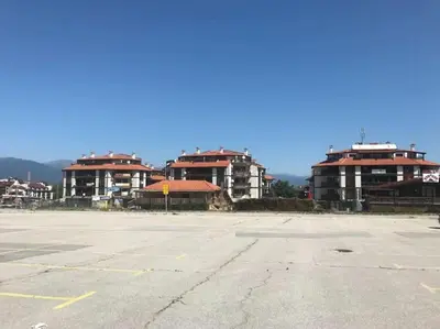 an empty parking lot with buildings in the background at Gondola lift apartment 5402 in Bansko