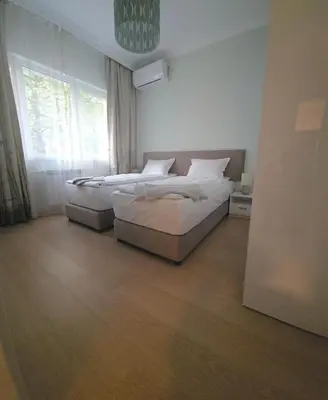 a bedroom with two beds and a window at Tsar Asen 21 in Sofia