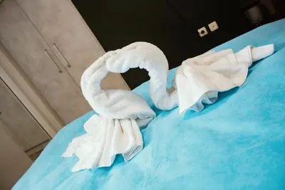a group of towels sitting on top of a bed at Guesthouse The Rock in Sapareva Banya