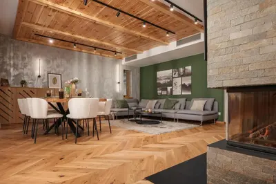a living room with a table and a fireplace at Luxury Villa with Hot Pool in Banya