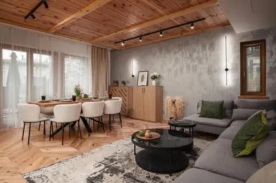 a living room with a couch and a table at Luxury Villa with Hot Pool in Banya