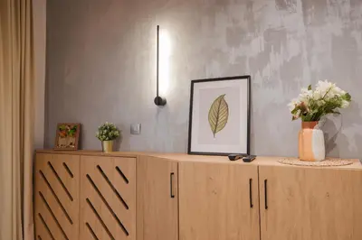 a wooden cabinet with a picture and flowers on it at Luxury Villa with Hot Pool in Banya