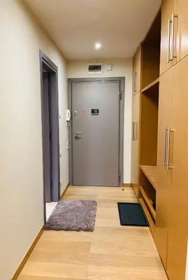 a hallway with a door and a rug in a room at Forest nest - your place to rest! in Borovets