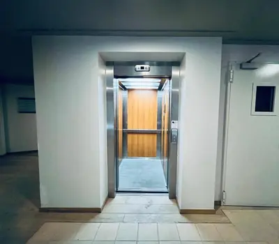 an open door to a hallway with a wooden door at Forest nest - your place to rest! in Borovets