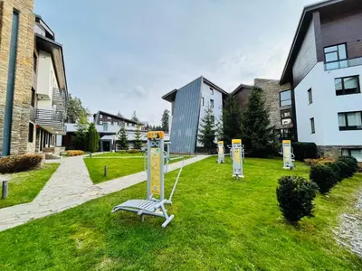 a park with a bench in the middle of a yard at Forest nest - your place to rest! in Borovets