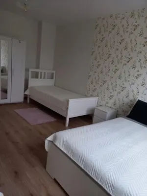 a bedroom with two beds and a wall at апартамент Римската стена in Hisarya
