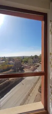 a window with a view of a street at апартамент Римската стена in Hisarya