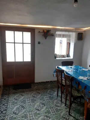 a dining room with a table and chairs and a door at Апартамент Стар стил Old style in Raduil