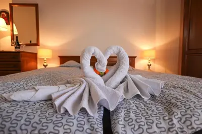 two towel swans sitting on top of a bed at Pirin Golf Mountain View Retreat in Razlog