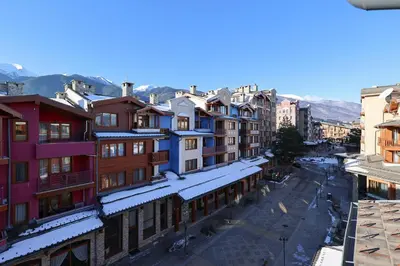 a view of a city with snow covered buildings at Pirin Golf Mountain View Retreat in Razlog