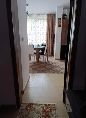 a living room with a table and a dining room at Flat Cedar Lodge 2min walk to gondola in Bansko