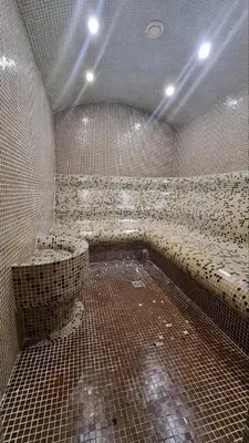 a large bathroom with tiled walls and a large tub at Studio Maria in Bansko