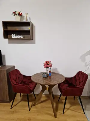 a table with two chairs and a table with flowers on it at Studio Maria in Bansko