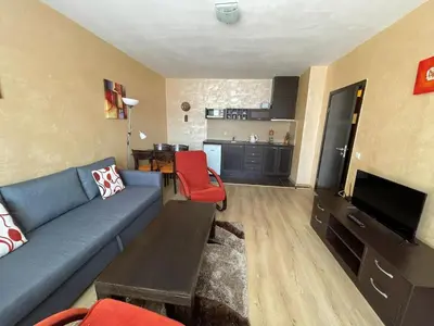 a living room with a blue couch and red chairs at Bansko Royal Towers Thea Apartment, modern renovated bathroom in Bansko