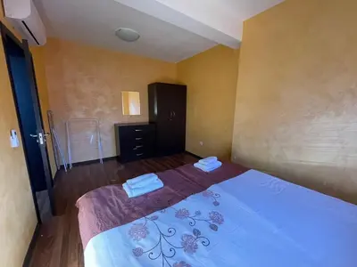 a bedroom with a bed with two towels on it at Bansko Royal Towers Thea Apartment, modern renovated bathroom in Bansko