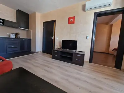 a living room with a flat screen tv on a table at Bansko Royal Towers Thea Apartment, modern renovated bathroom in Bansko