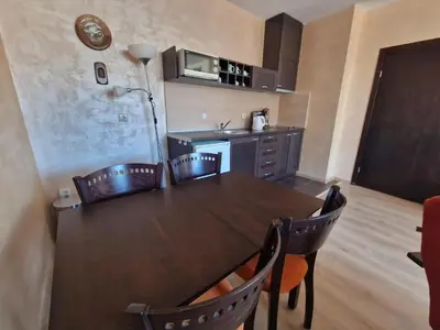 a kitchen with a table and chairs in a room at Bansko Royal Towers Thea Apartment, modern renovated bathroom in Bansko