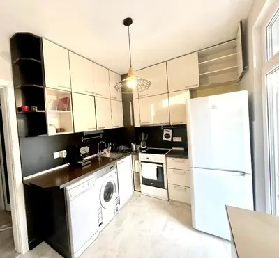 a kitchen with a white refrigerator and a dishwasher at Dreamy Apartment Near To The Center in Sofia