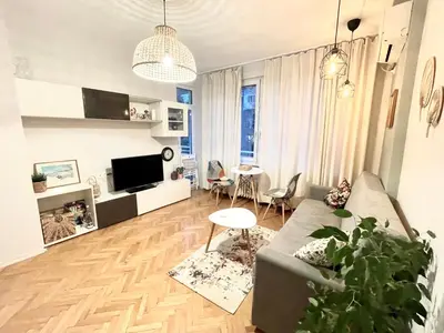 a living room with a couch and a table at Dreamy Apartment Near To The Center in Sofia