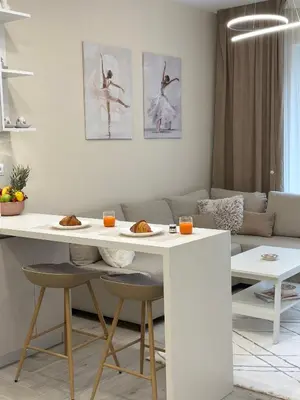 a living room with a white table with two chairs at Мoka Apartment in Sofia