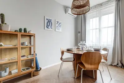 a dining room with a wooden table and chairs at Sofia's Elegant Urban Retreat in Sofia