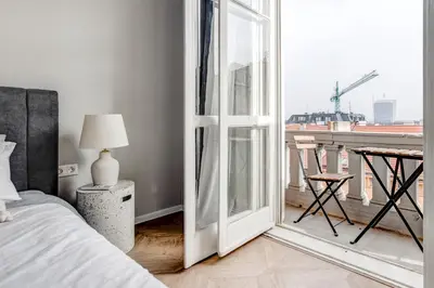 a bedroom with a bed and a sliding glass door at Sofia's Elegant Urban Retreat in Sofia