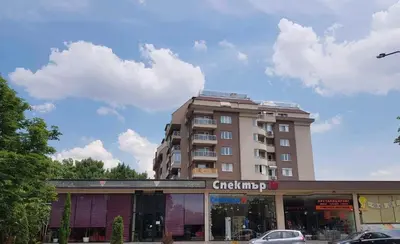 a tall building in front of a building at Lucky7Lux1 in Pazardzhik