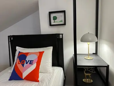 a bedroom with a bed with a love pillow and a lamp at Sana Ski apartment 702 in Flora, Borovets in Borovets