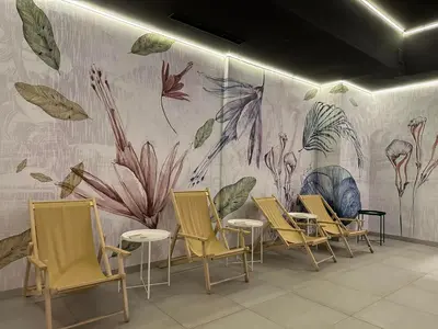 a room with chairs and a wall with a mural at Sana Ski apartment 702 in Flora, Borovets in Borovets