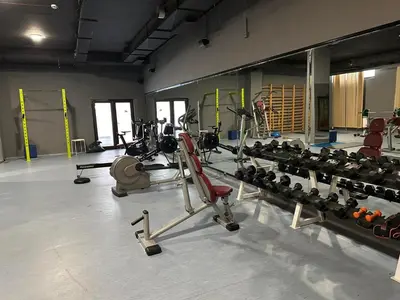 a gym with a bunch of equipment in a room at Sana Ski apartment 702 in Flora, Borovets in Borovets