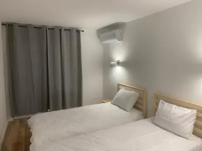 two beds with white sheets in a room at Мотел Тихия кът in Sofia