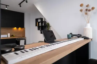a keyboard sitting on top of a desk with a laptop at Chic 1BR Apartment with Balcony in Plovdiv in Plovdiv