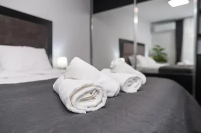 two towels are sitting on top of a bed at Chic 1BR Apartment with Balcony in Plovdiv in Plovdiv