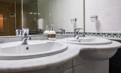 a bathroom with two sinks and a large mirror at Hotel Royal Borovets in Borovets
