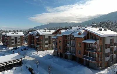 a group of apartment buildings in the snow at Spacious penthouse chalet apartment in Pirin Golf and Country Club in Razlog
