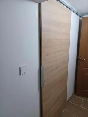 a sliding door in a room with a wooden door at Top Center Studio 5 in Sofia