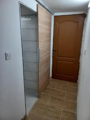 a walk in shower with a door and a tile floor at Top Center Studio 5 in Sofia