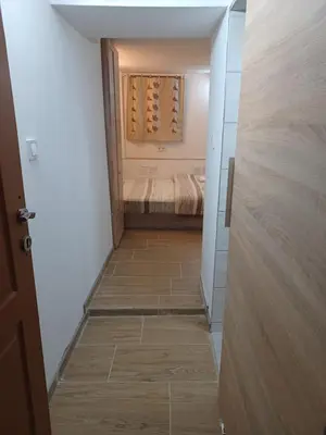 a hallway with a room with a closet with wine bottles at Top Center Studio 5 in Sofia