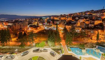 a city at night with cars parked in a parking lot at 2 Bedroom Apartment with Garage in Sandanski