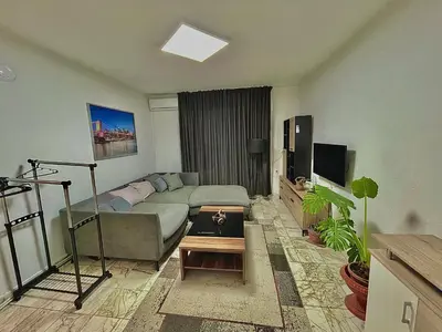 a living room with a couch and a tv at 2 Bedroom Apartment with Garage in Sandanski
