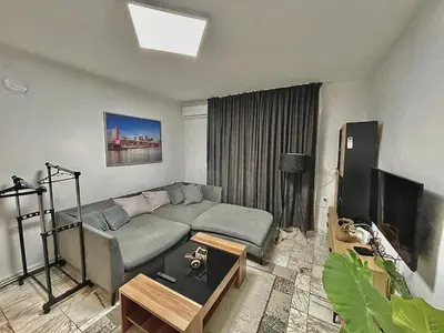 a living room with a couch and a television at 2 Bedroom Apartment with Garage in Sandanski