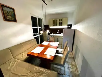 a living room with a couch and a wooden table at 2 Bedroom Apartment with Garage in Sandanski